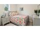 Cozy bedroom with a patterned quilt and floral pillows, complemented by a grey nightstand and picture frame at 106 Thornwood Dr, Woodstock, GA 30188