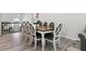 Dining area with a wooden table and upholstered chairs, adjacent to the staircase at 106 Thornwood Dr, Woodstock, GA 30188