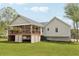 Beautifully maintained home featuring a covered patio and well-manicured lawn at 106 Thornwood Dr, Woodstock, GA 30188
