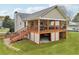 Charming home boasts a covered patio with stairs leading to the spacious backyard at 106 Thornwood Dr, Woodstock, GA 30188