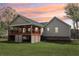Back exterior view featuring a covered patio perfect for outdoor relaxation and entertainment at 106 Thornwood Dr, Woodstock, GA 30188