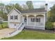 Charming home featuring a covered front porch, well-manicured lawn, and attached two-car garage at 106 Thornwood Dr, Woodstock, GA 30188
