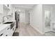 Modern white kitchen featuring stainless steel appliances, granite countertops, and hardwood flooring at 106 Thornwood Dr, Woodstock, GA 30188