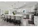 Spacious kitchen featuring white cabinets, stainless steel appliances, and a large island with seating at 106 Thornwood Dr, Woodstock, GA 30188