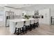 Bright kitchen with white cabinets, stainless appliances, large island, and counter seating at 106 Thornwood Dr, Woodstock, GA 30188