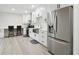 Modern kitchen featuring white cabinets, stainless steel appliances, and a breakfast bar for a stylish and functional cooking space at 106 Thornwood Dr, Woodstock, GA 30188