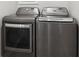 Modern laundry room features stainless steel washer and dryer at 106 Thornwood Dr, Woodstock, GA 30188