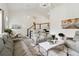 Bright living room features a modern staircase, elegant leather seating, and marble-top coffee table at 106 Thornwood Dr, Woodstock, GA 30188