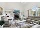 Bright living room features a stone fireplace, built-in shelves, and elegant leather seating at 106 Thornwood Dr, Woodstock, GA 30188