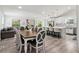 Open-concept living and kitchen area with modern cabinetry, dining area and hardwood floors at 106 Thornwood Dr, Woodstock, GA 30188
