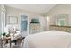 Bedroom with a king bed, dresser, armchair, and a view of the en suite bathroom at 106 Thornwood Dr, Woodstock, GA 30188