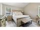 Bedroom with a king bed, side tables, lamps, and hardwood flooring at 106 Thornwood Dr, Woodstock, GA 30188