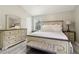 Bedroom with a king bed, side tables, lamps, and hardwood flooring at 106 Thornwood Dr, Woodstock, GA 30188
