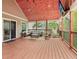 Spacious covered patio boasts comfortable seating and a mounted television for outdoor entertainment at 106 Thornwood Dr, Woodstock, GA 30188