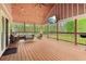 Inviting covered patio with wood ceiling, ceiling fan, television, and comfortable seating area at 106 Thornwood Dr, Woodstock, GA 30188