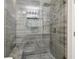 Stylish glass shower showcasing modern design, stone bench, gray tiling, and accent niche for a luxurious bathing experience at 106 Thornwood Dr, Woodstock, GA 30188