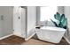 Serene bathroom featuring a soaking tub, walk-in shower, and stylish decor at 319 Overlook Rd, Covington, GA 30014