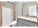 Clean bathroom with a shower and granite countertops over a gray vanity at 319 Overlook Rd, Covington, GA 30014