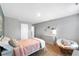 Light and airy bedroom featuring a comfy wicker chair and a modern white dresser at 319 Overlook Rd, Covington, GA 30014