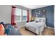 Comfortable bedroom with a calming blue accent wall, window, and playful decor at 319 Overlook Rd, Covington, GA 30014