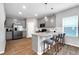 Modern kitchen with stainless steel appliances, a spacious island, and stylish light fixtures at 319 Overlook Rd, Covington, GA 30014