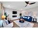Cozy living room with elegant decor, featuring a ceiling fan, fireplace and modern accents at 319 Overlook Rd, Covington, GA 30014