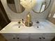 Bathroom with a double sink vanity and round mirrors at 3627 Mcclaren Way, Lawrenceville, GA 30044