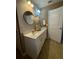 Bathroom featuring a double sink vanity, round mirrors, and tile flooring at 3627 Mcclaren Way, Lawrenceville, GA 30044