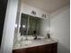 Bathroom featuring a double vanity sink with a large mirror and lighting at 3627 Mcclaren Way, Lawrenceville, GA 30044