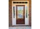 Inviting front door with glass panes, decorative sidelights, a brick surround, and a welcome mat at 3627 Mcclaren Way, Lawrenceville, GA 30044