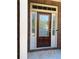 Inviting front door with glass panes, decorative sidelights, a brick surround, and a welcome mat at 3627 Mcclaren Way, Lawrenceville, GA 30044