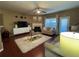 Comfortable living room boasts a fireplace, ceiling fan, and access to natural light from a sliding door at 3627 Mcclaren Way, Lawrenceville, GA 30044