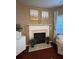 Cozy living room featuring a fireplace, artwork, and natural lighting at 3627 Mcclaren Way, Lawrenceville, GA 30044