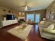 Comfortable living room boasts a fireplace, ceiling fan, and natural light from a large window and sliding door at 3627 Mcclaren Way, Lawrenceville, GA 30044