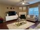 Spacious living room featuring a fireplace, a modern TV unit, and comfortable seating at 3627 Mcclaren Way, Lawrenceville, GA 30044