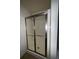 Enclosed shower with clear glass doors and built-in bench at 3627 Mcclaren Way, Lawrenceville, GA 30044
