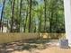 A new fence provides privacy in the spacious backyard surrounded by a lush green tree line at 6213 Marbut Farms Chase, Lithonia, GA 30058