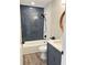 Modern bathroom with vertical subway tiles, tub and shower combo, and vanity at 6213 Marbut Farms Chase, Lithonia, GA 30058