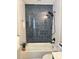 Bathroom featuring vertically stacked subway tiles and a shower over tub at 6213 Marbut Farms Chase, Lithonia, GA 30058