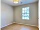 Bedroom featuring natural light, neutral paint, wood floor and modern light fixture at 6213 Marbut Farms Chase, Lithonia, GA 30058