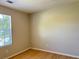 A bright bedroom with laminate floors and natural light from a large window at 6213 Marbut Farms Chase, Lithonia, GA 30058