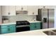 Contemporary kitchen features a stainless steel refrigerator, oven, and sleek cabinets with a modern backsplash at 6213 Marbut Farms Chase, Lithonia, GA 30058