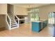 Bright, open-concept kitchen features a large island with modern appliances and adjacent staircase at 6213 Marbut Farms Chase, Lithonia, GA 30058
