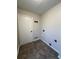 A bright, small laundry room with tile floor, and white door at 6213 Marbut Farms Chase, Lithonia, GA 30058