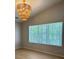 Living Room with large window and vaulted ceiling with modern light fixture at 6213 Marbut Farms Chase, Lithonia, GA 30058