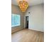 Living room features vaulted ceiling, modern light fixture, and a large window at 6213 Marbut Farms Chase, Lithonia, GA 30058
