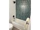Bathroom features white and blue vertical tile, a shower head and tub at 6213 Marbut Farms Chase, Lithonia, GA 30058