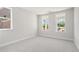 Spacious bedroom with natural light from large windows offering picturesque views at 920 Melody Ridge Ln, Buford, GA 30518
