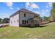 New construction home featuring a large backyard, trees, and blue skies at 920 Melody Ridge Ln, Buford, GA 30518