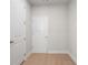 Hallway with light wood floors, white trim and white doors at 920 Melody Ridge Ln, Buford, GA 30518